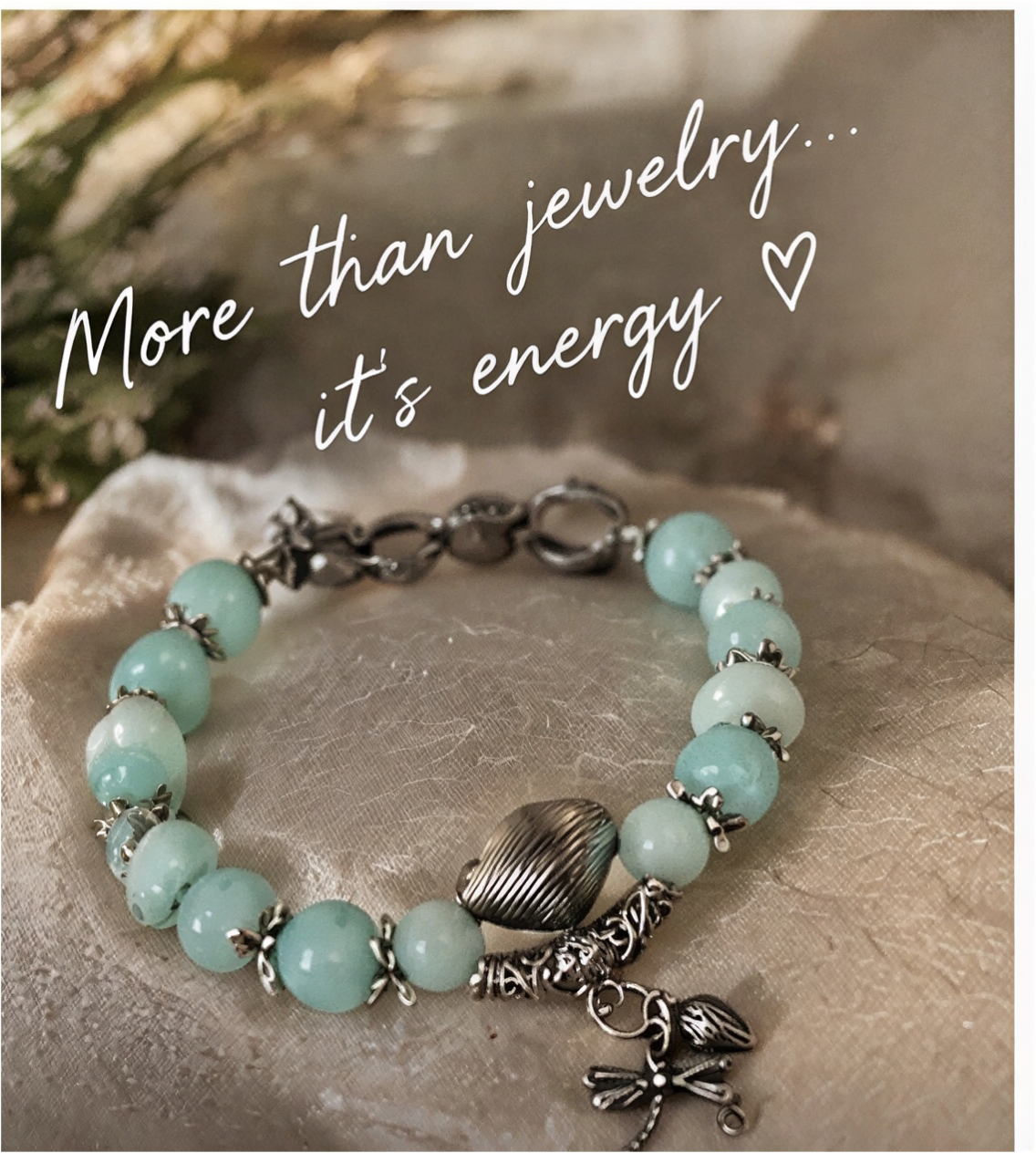 Larimar bracelet with dragonfly and leaf charms beneath the words More than jewelry, it's energy.