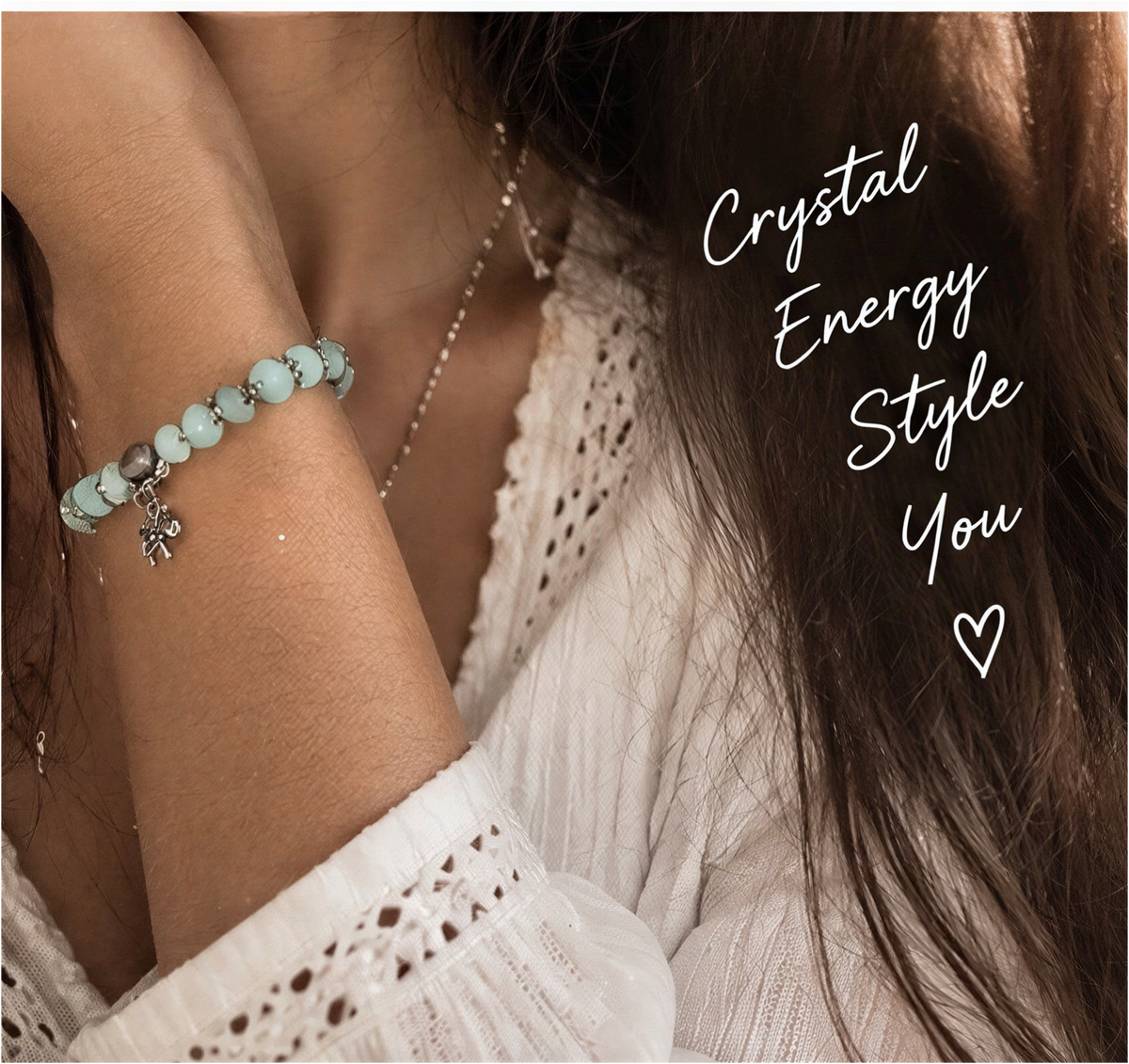 Larimar dragonfly charm bracelet held in a palm, showing pale aqua beads and silver-tone bead caps.