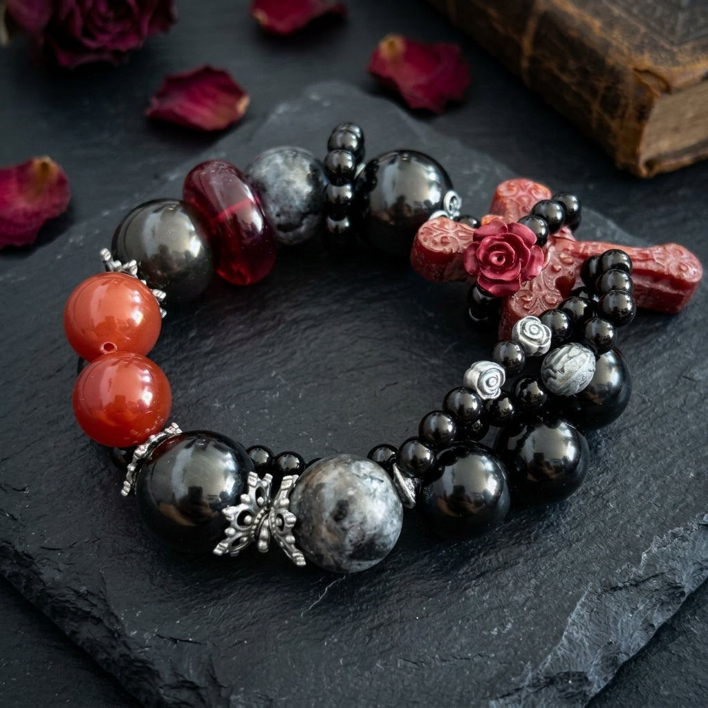 Carnelian cross bracelet held in hand showing cross pendant detail