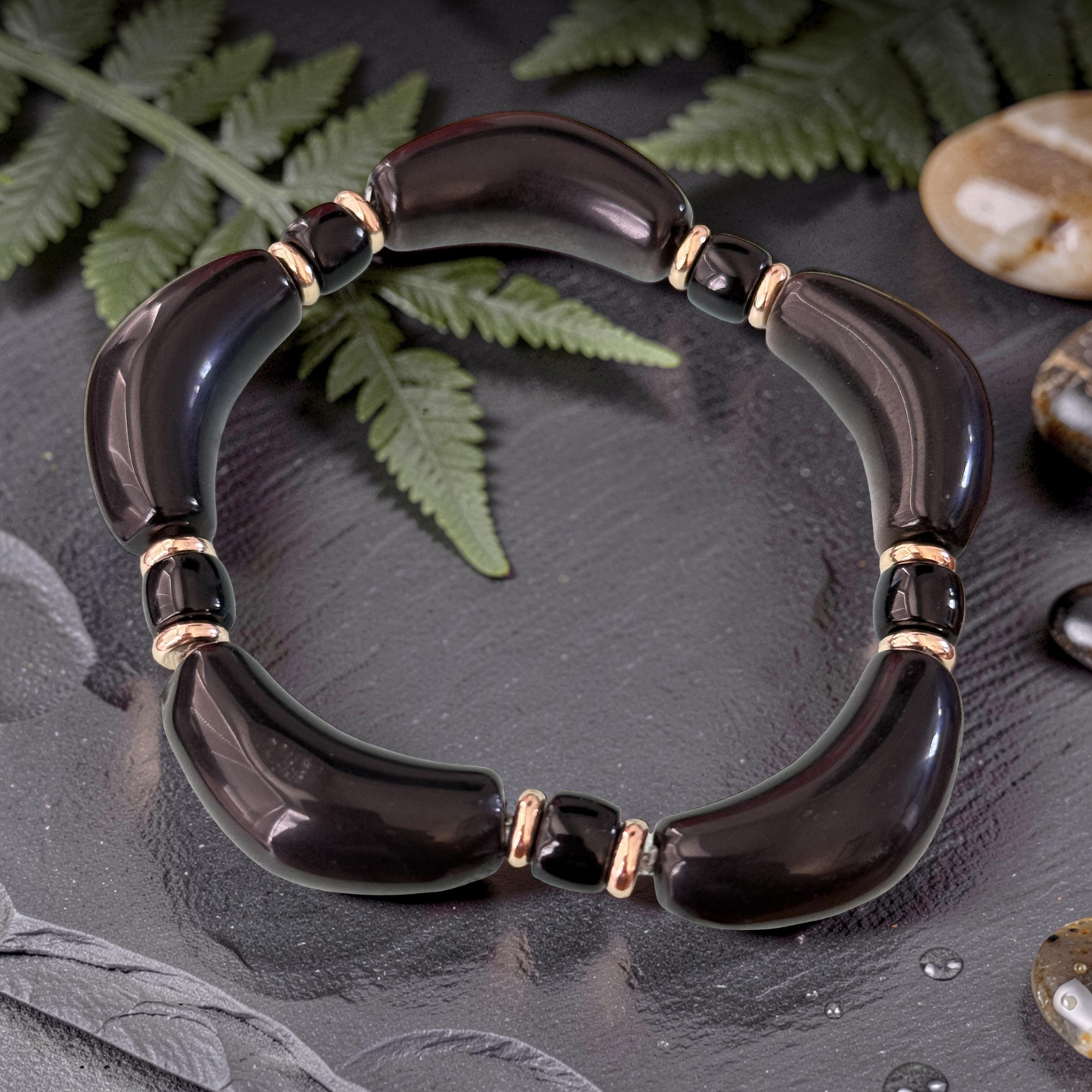 Silver Obsidian Bracelet flat lay on slate with river stones