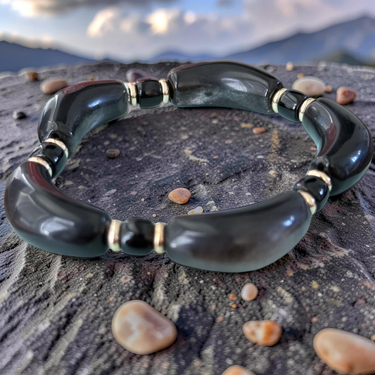 Silver Obsidian Bracelet worn on wrist with fern leaves