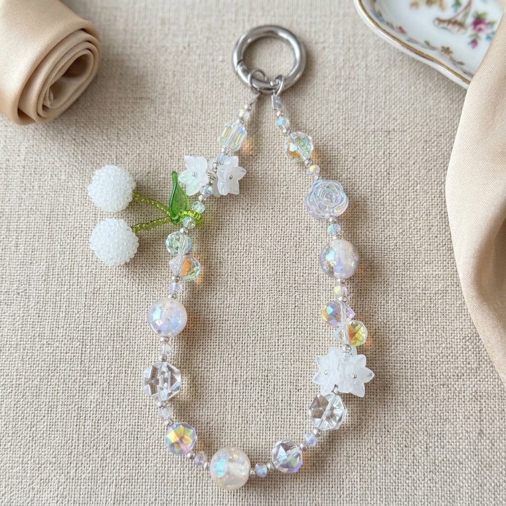 White Cherry Blossom Enchanted Garden Charm hanging on a cream quilted bag